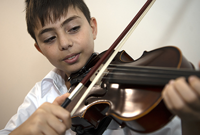 Holy Spirit Lakemba male student learns the violin